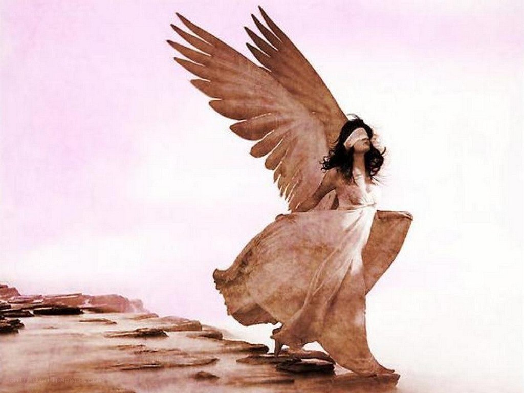 angel with blindfold on beach