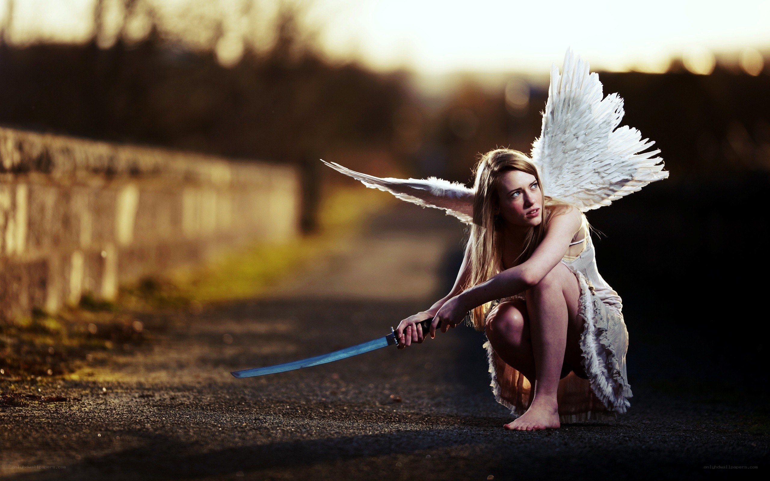 angel with sword crouching