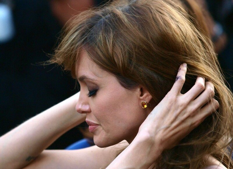 Angelina Jolie adjusting hair