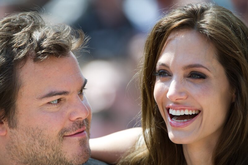 Angelina Jolie laughing with a man
