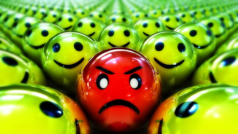 angry face among smiling faces