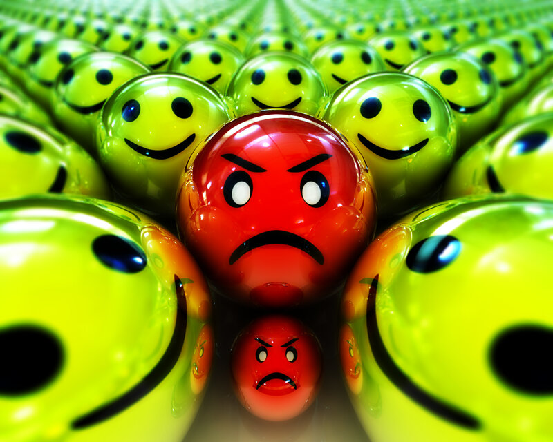 angry red face among green smileys