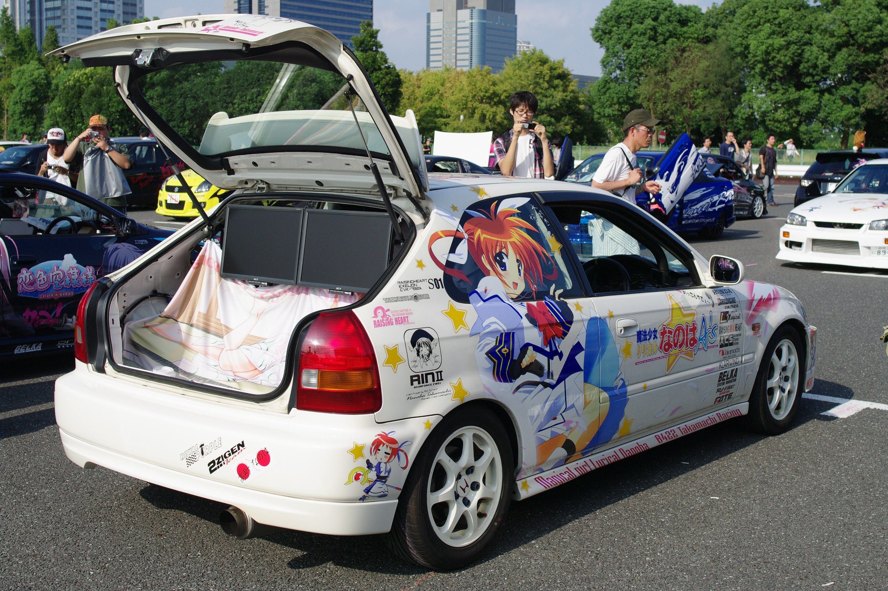 Anime-decorated car at a show