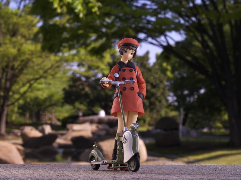 Anime figure on scooter in park
