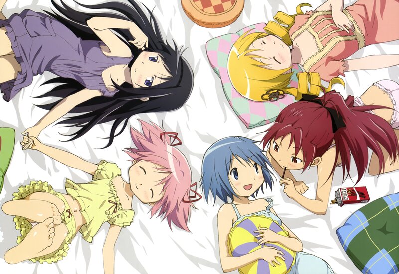 Anime girls relaxing on a bed