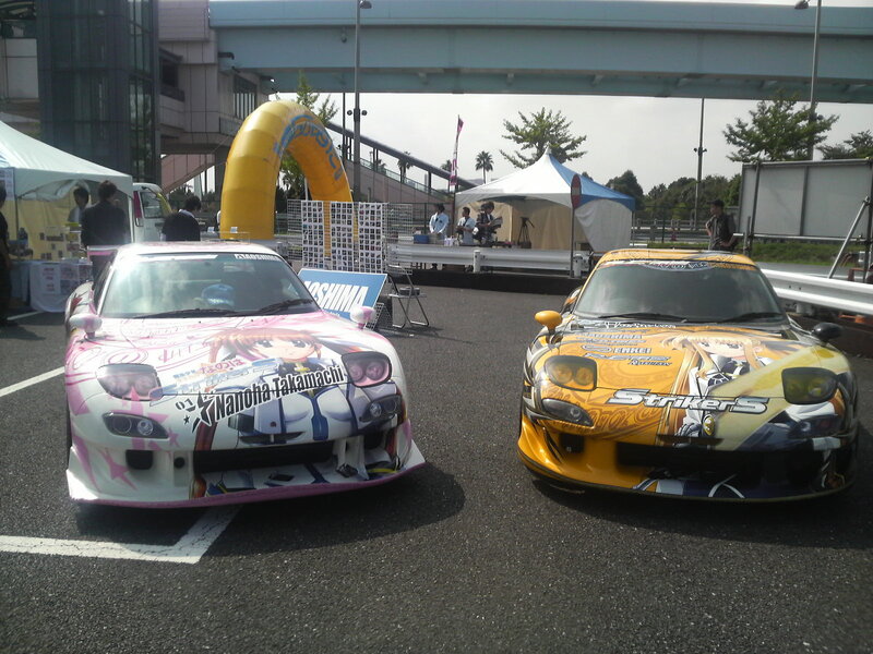 Anime-themed race cars at event