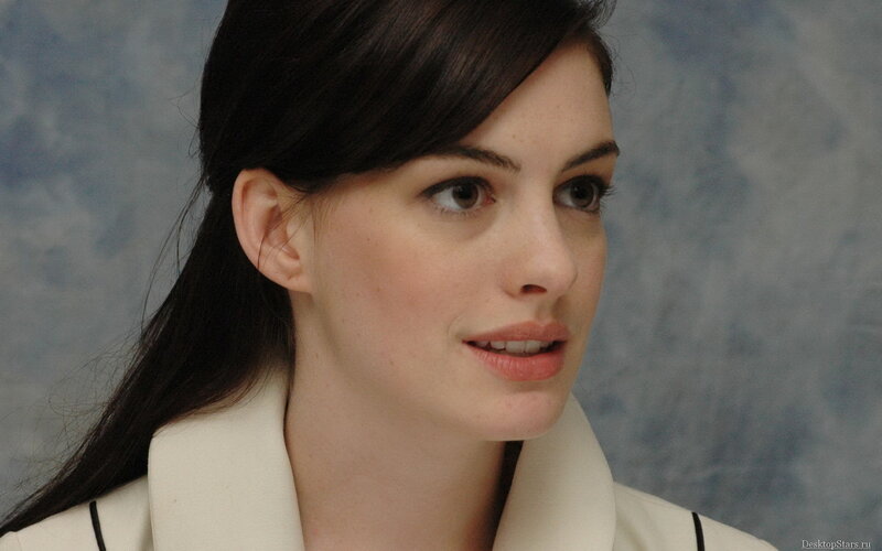 Anne Hathaway in a white coat
