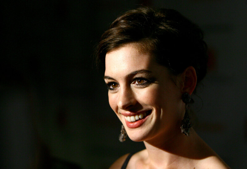 Anne Hathaway smiling at event