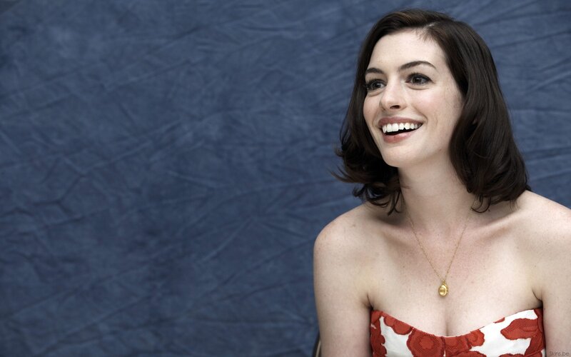 Anne Hathaway smiling in red dress