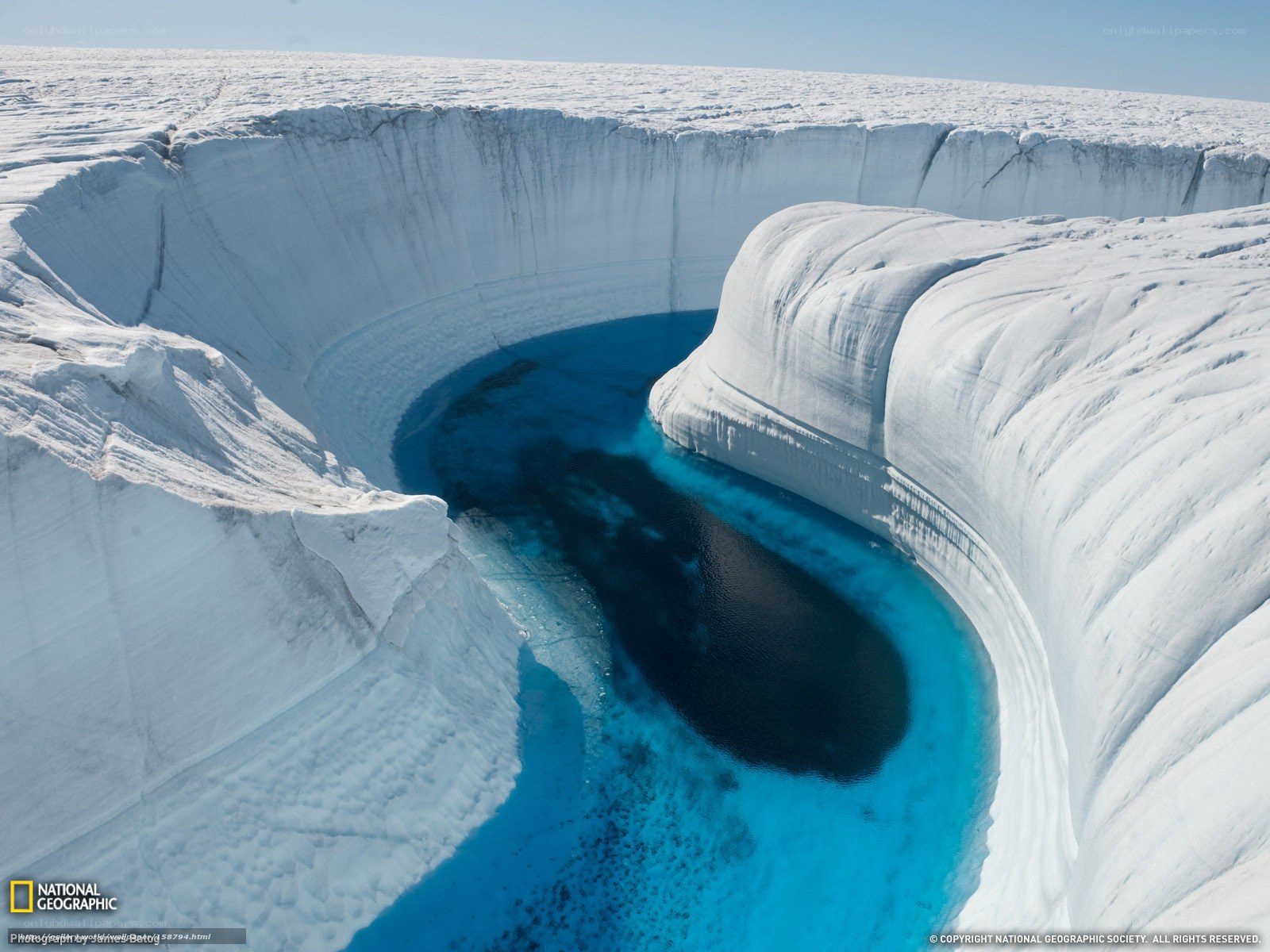 Antarctic ice cave with blue water