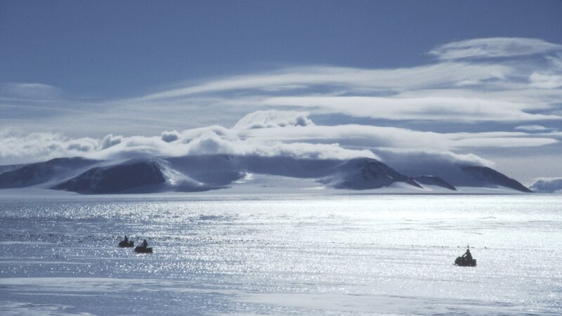 Antarctic ice field with snowmobiles