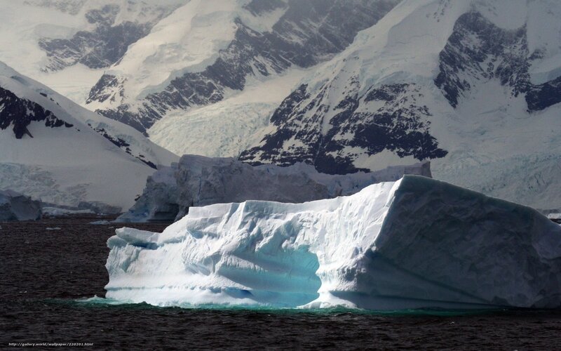 Antarctic iceberg and mountains