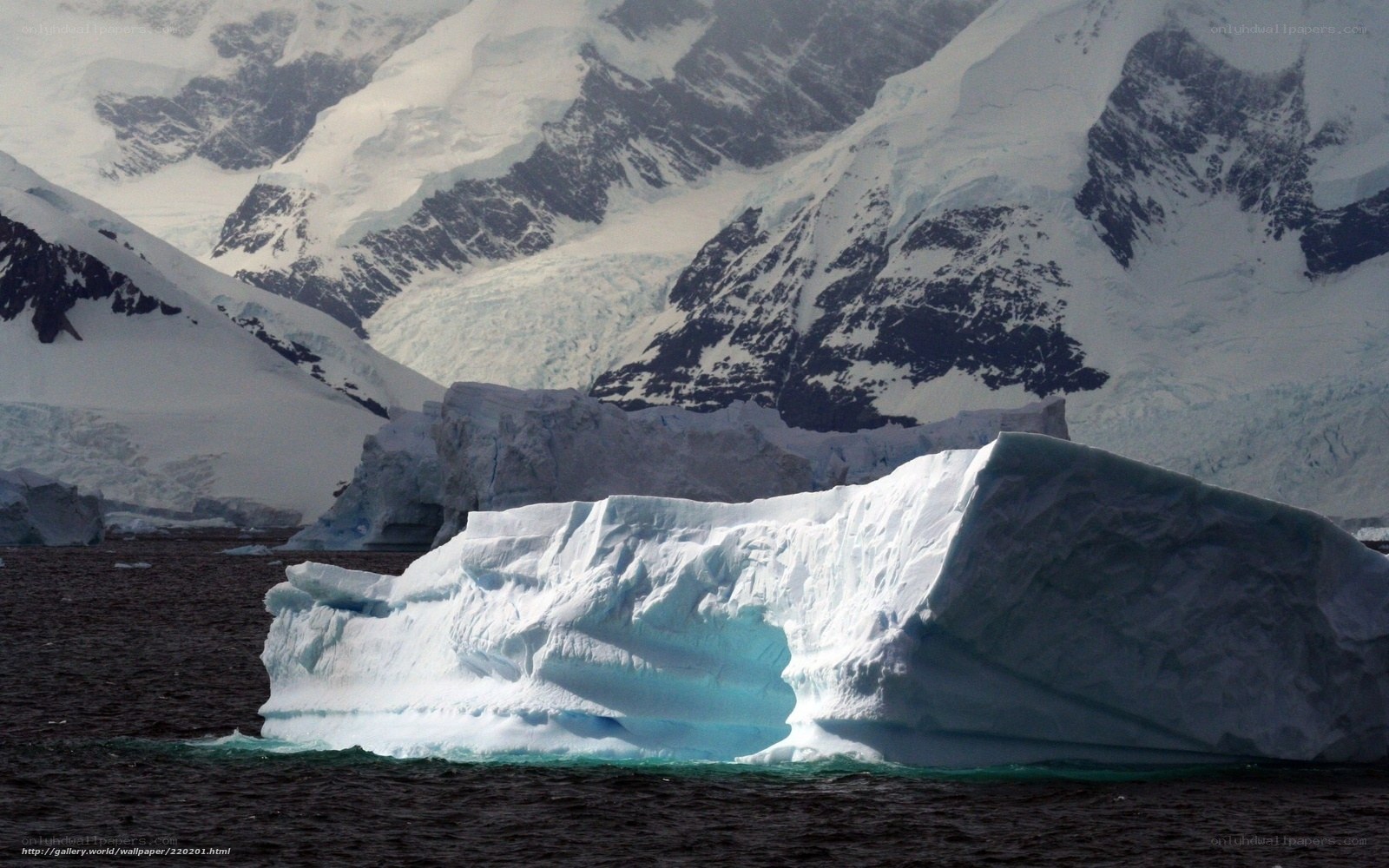 Antarctic iceberg and mountains