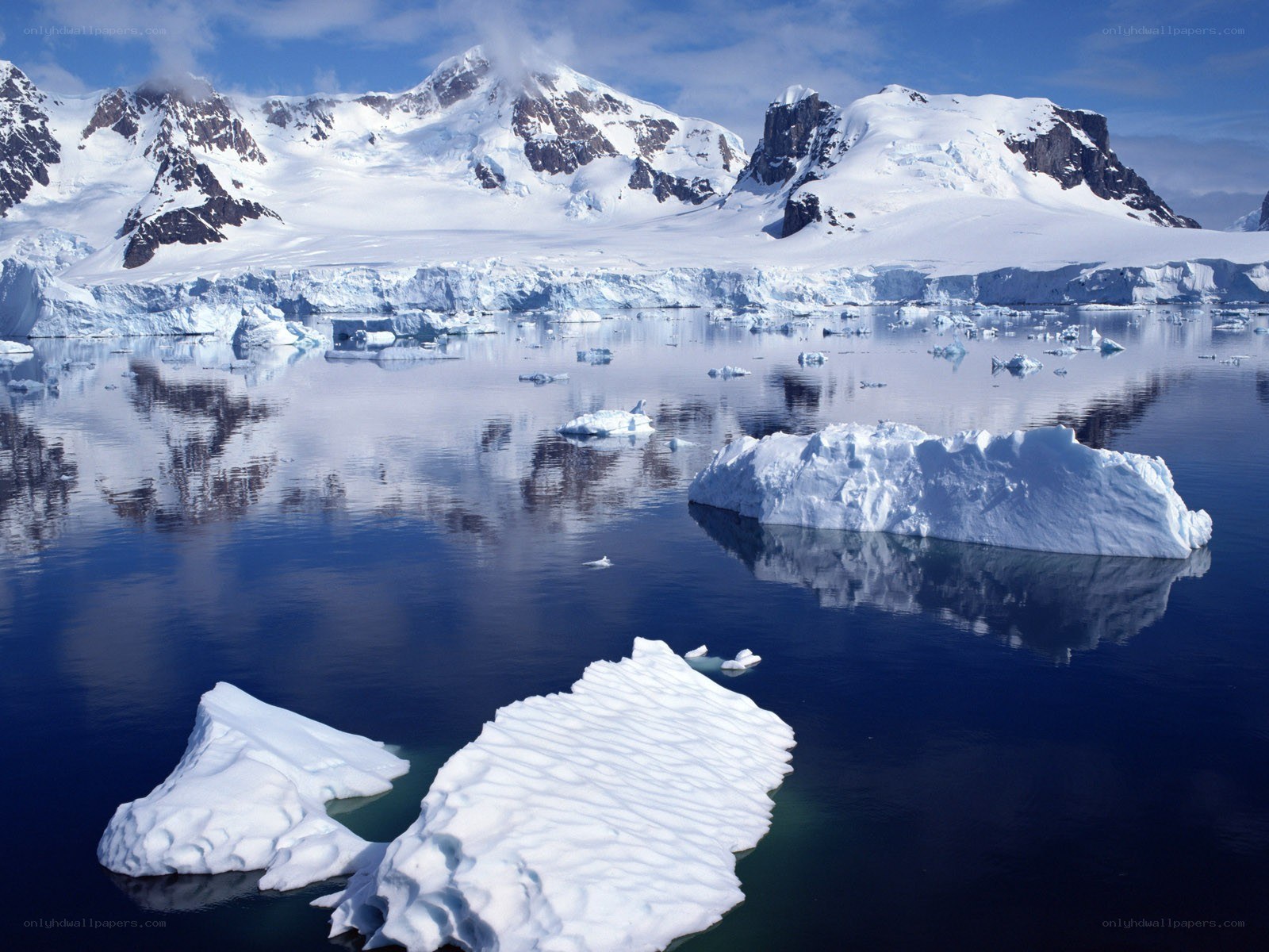 Antarctic icebergs and mountains