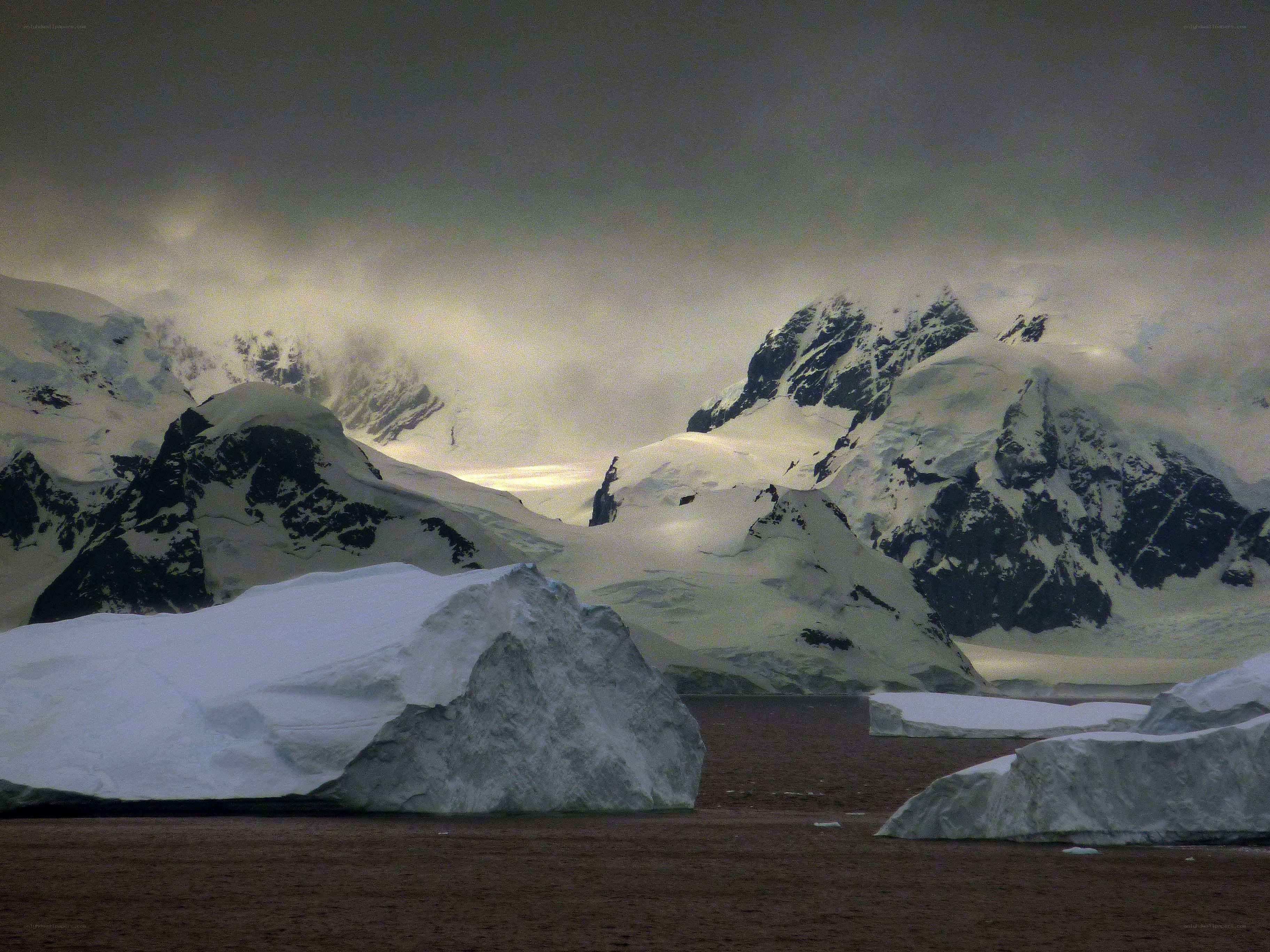 Antarctic icebergs and mountains