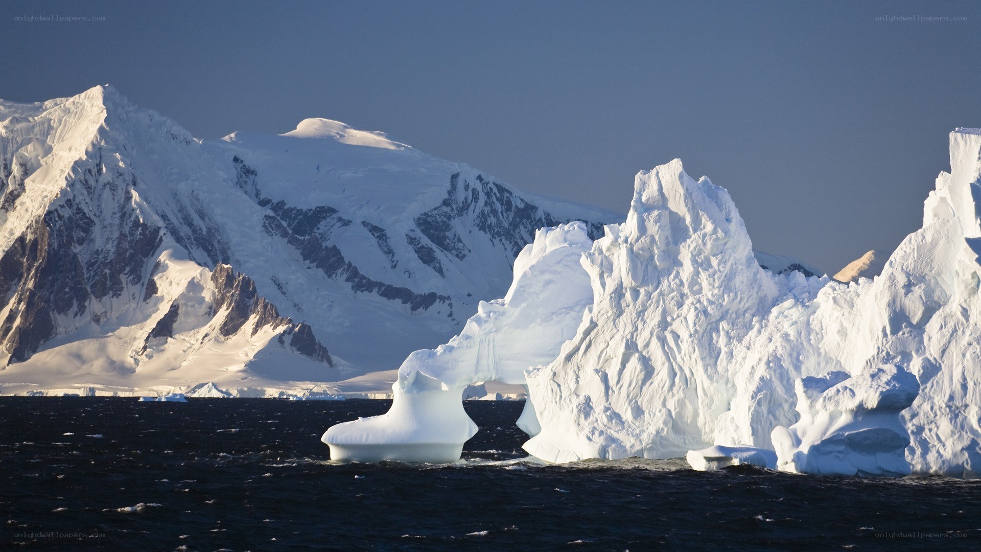 Antarctic icebergs and mountains