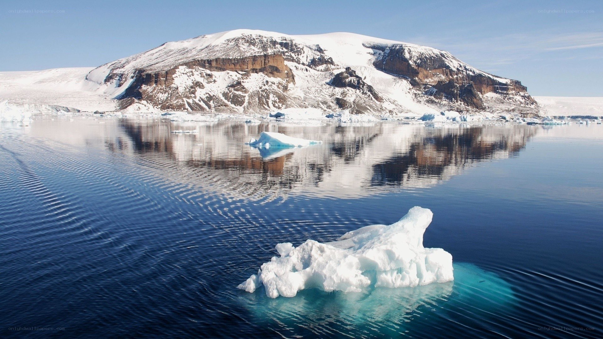 Antarctic icebergs and mountains