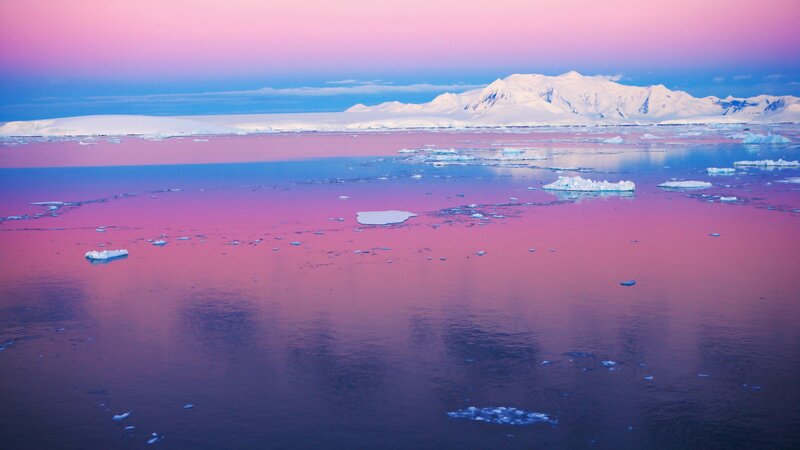 Antarctic sunset with icebergs