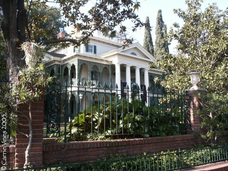antebellum-style house with iron fence
