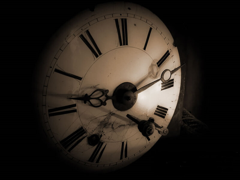antique clock face in darkness