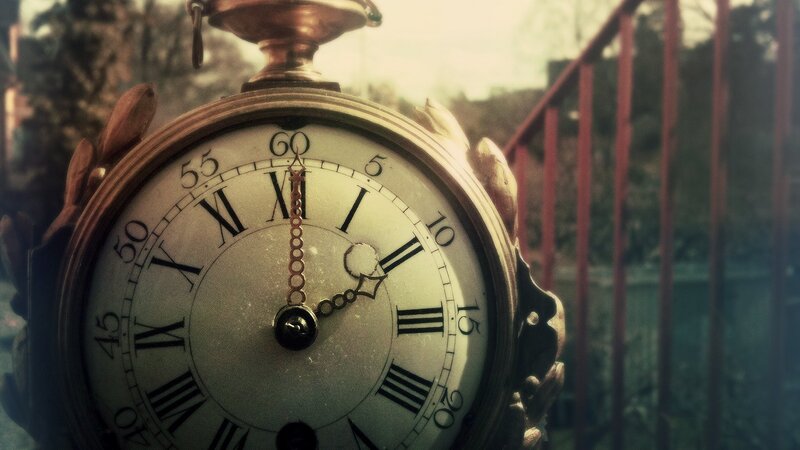 antique clock on a railing