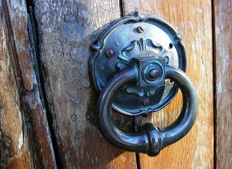 antique door knocker on wooden door