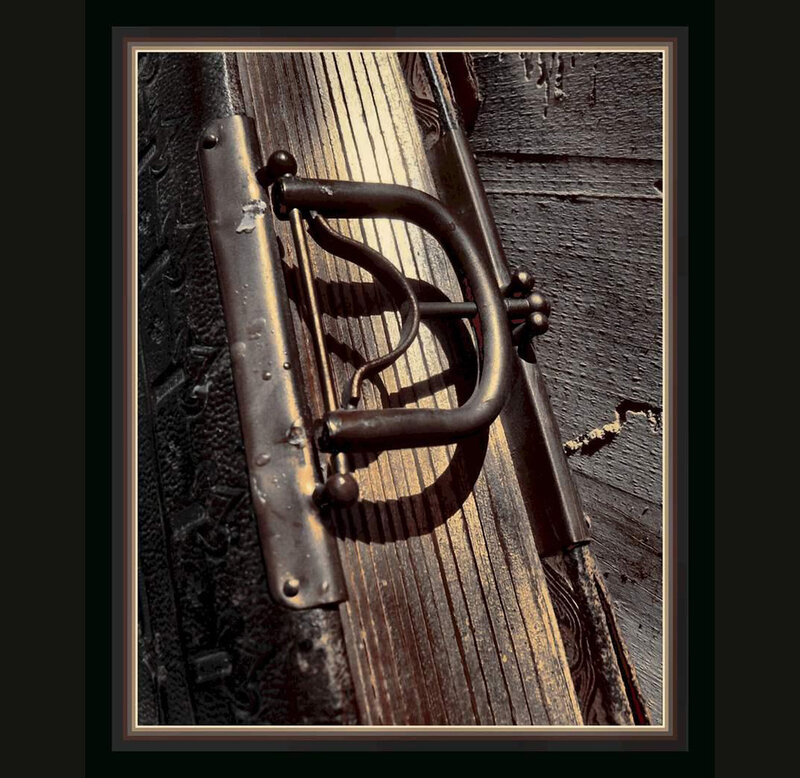 antique metal latch on wooden door