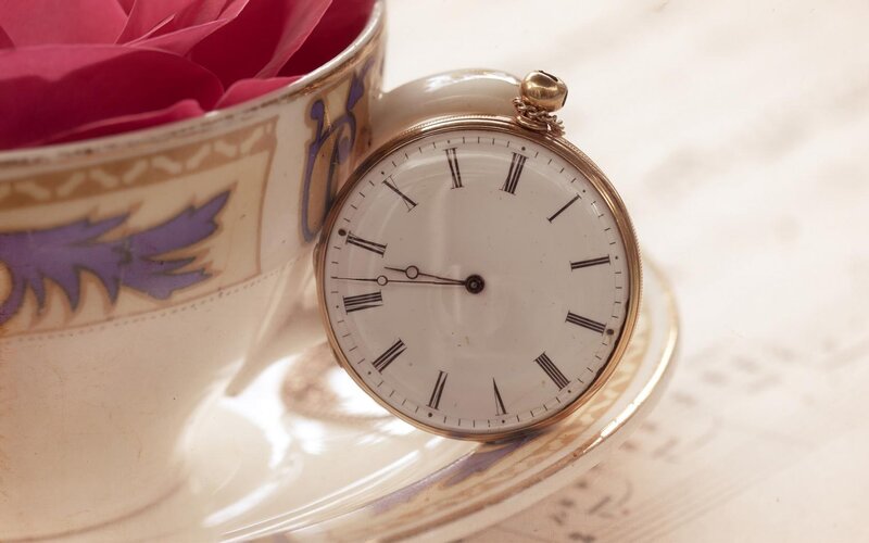 antique pocket watch and teacup