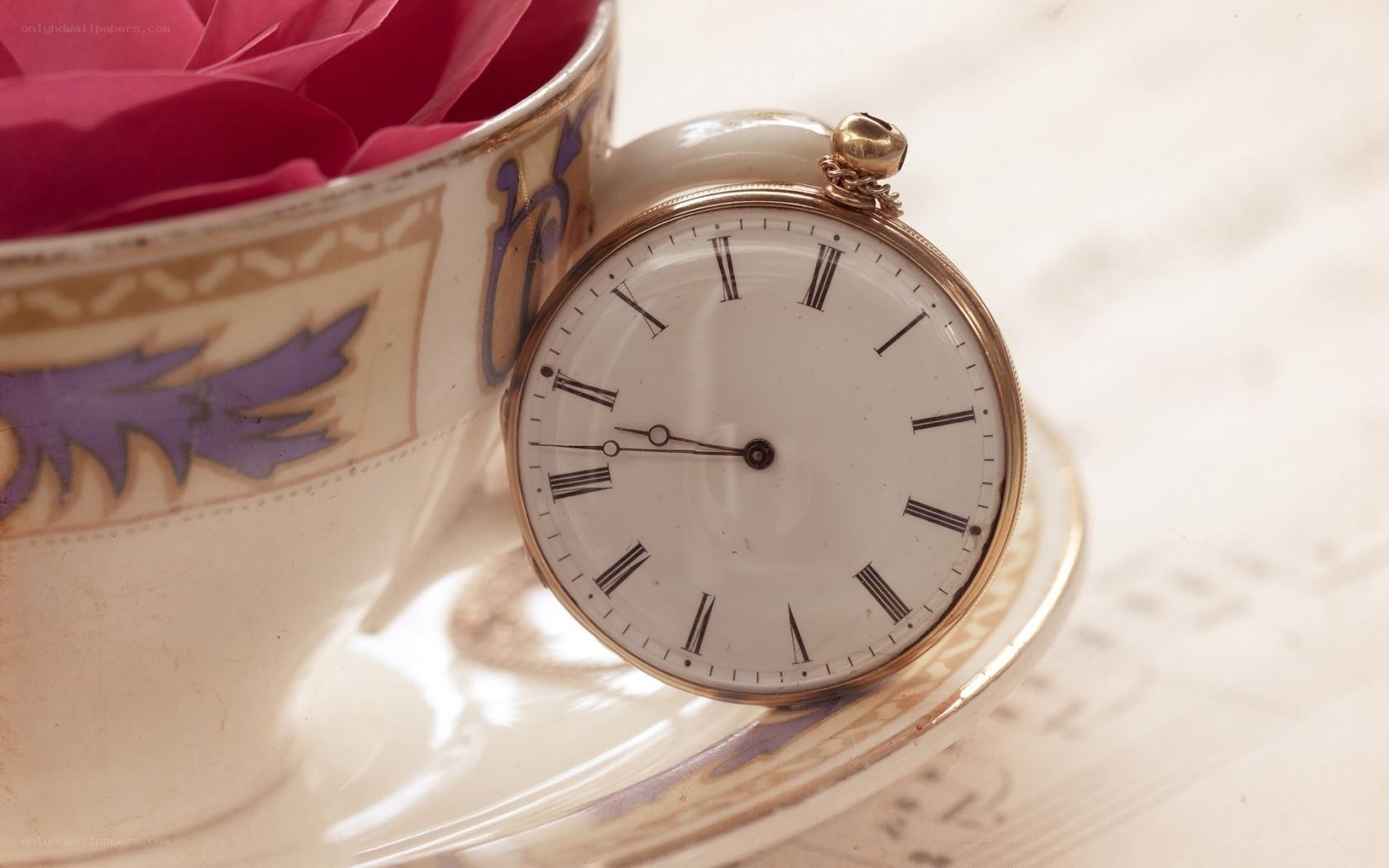 antique pocket watch and teacup