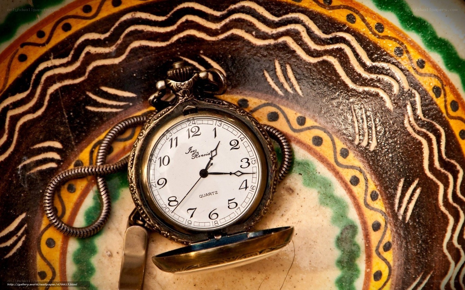 antique pocket watch on patterned plate