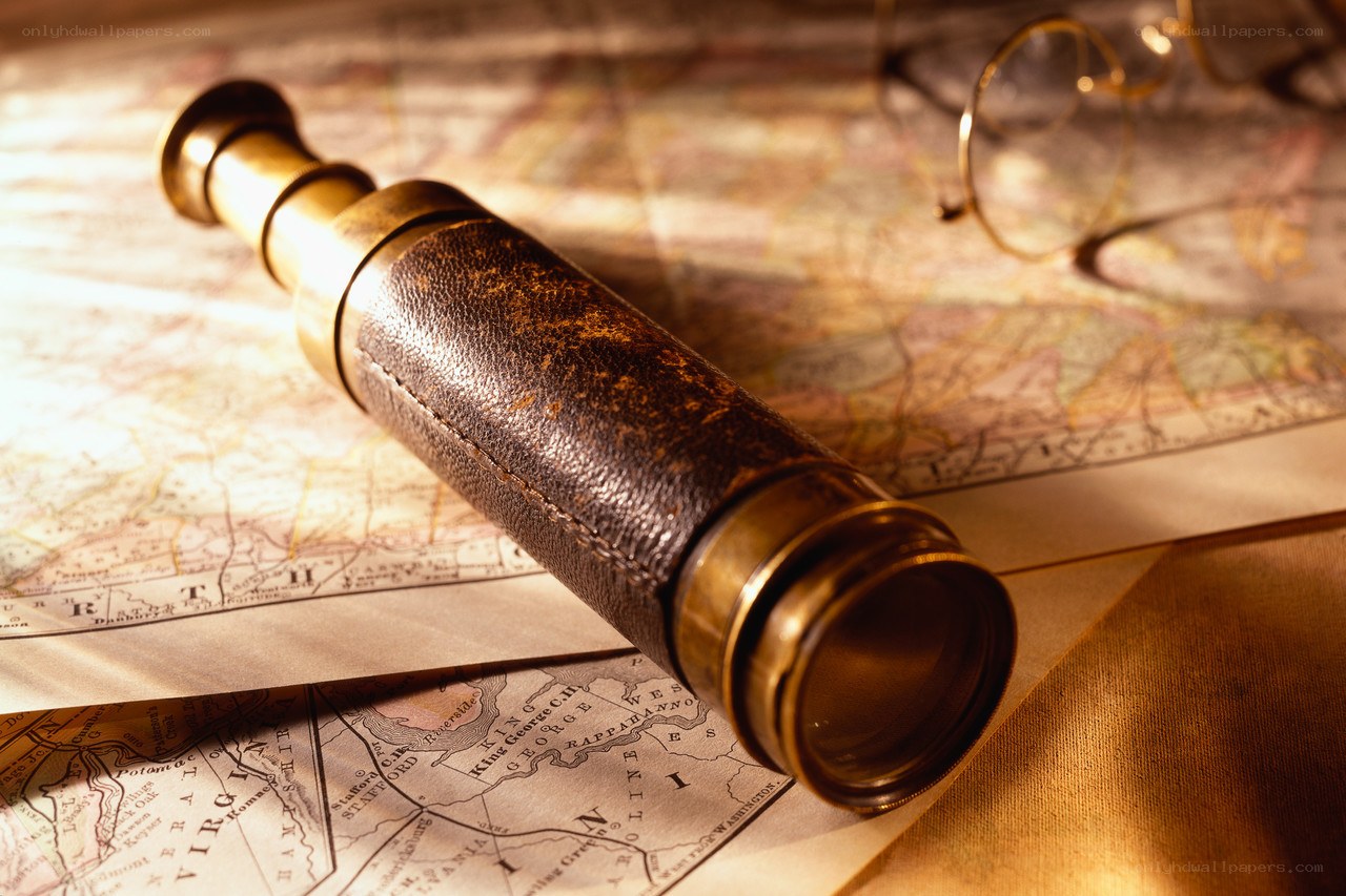 antique spyglass on map