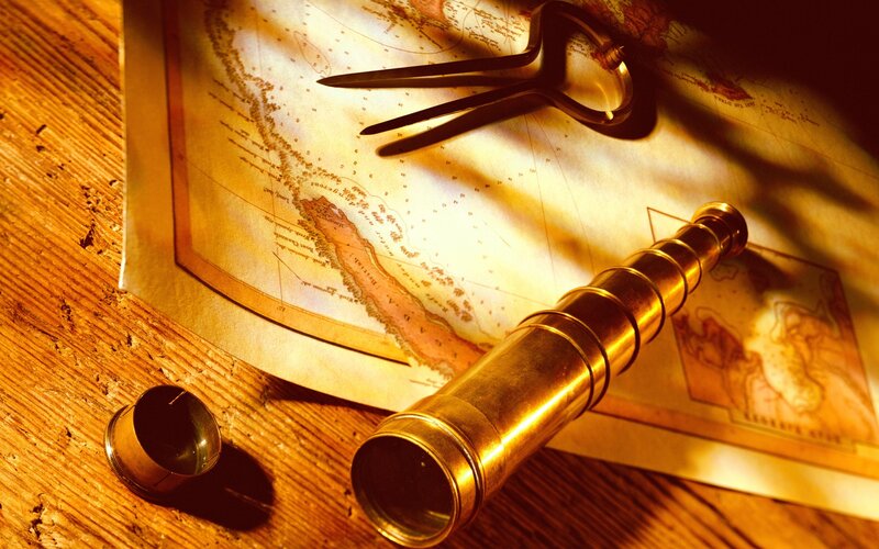 antique telescope on map