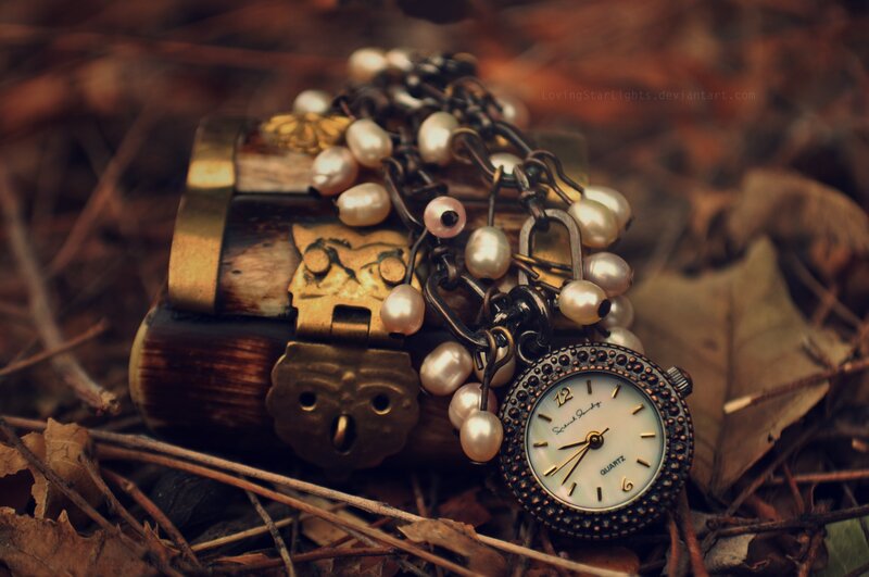 antique watch and pearls on chest