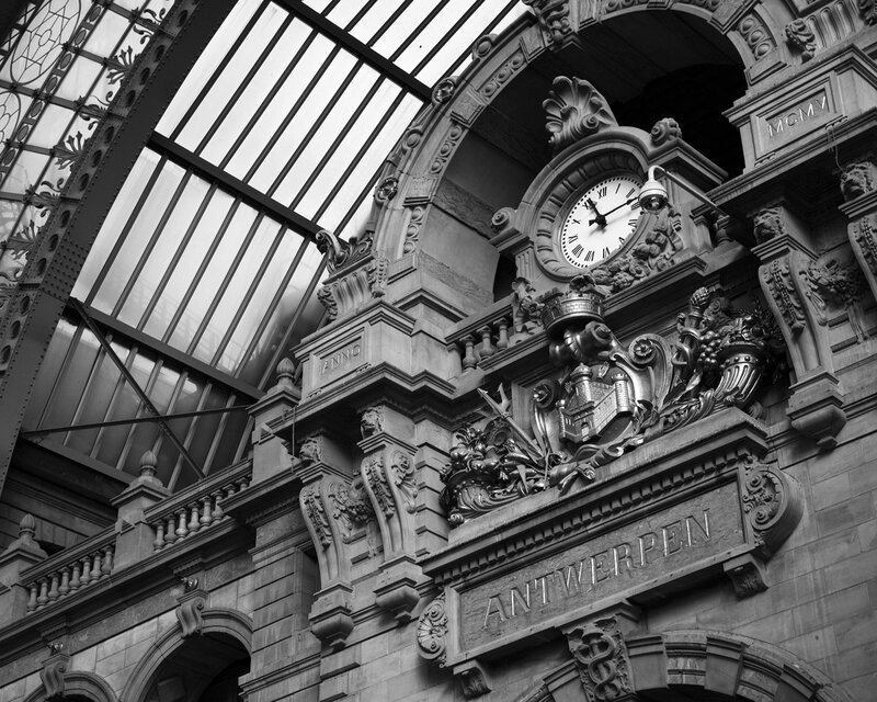 Antwerp Train Station Clock — Black, Dramatic, Photograph, Ornate Architecture, Glass Roof