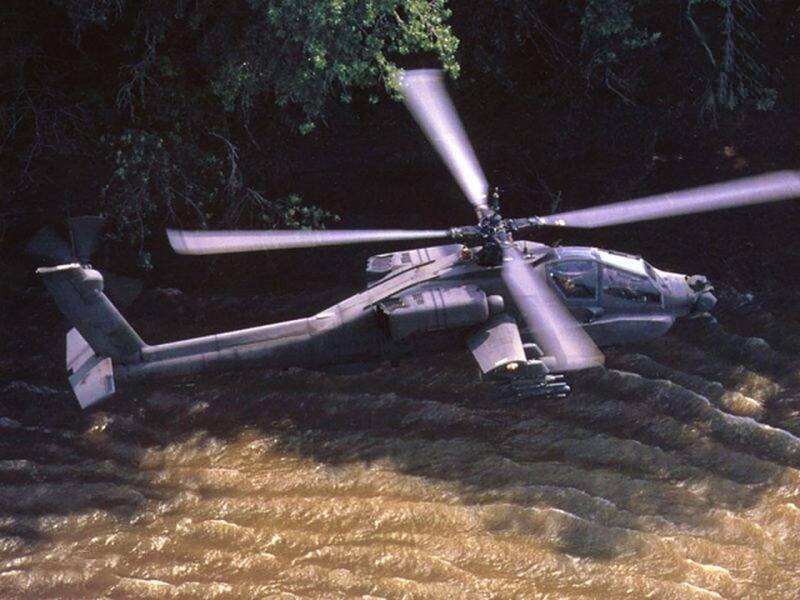 Apache helicopter over river