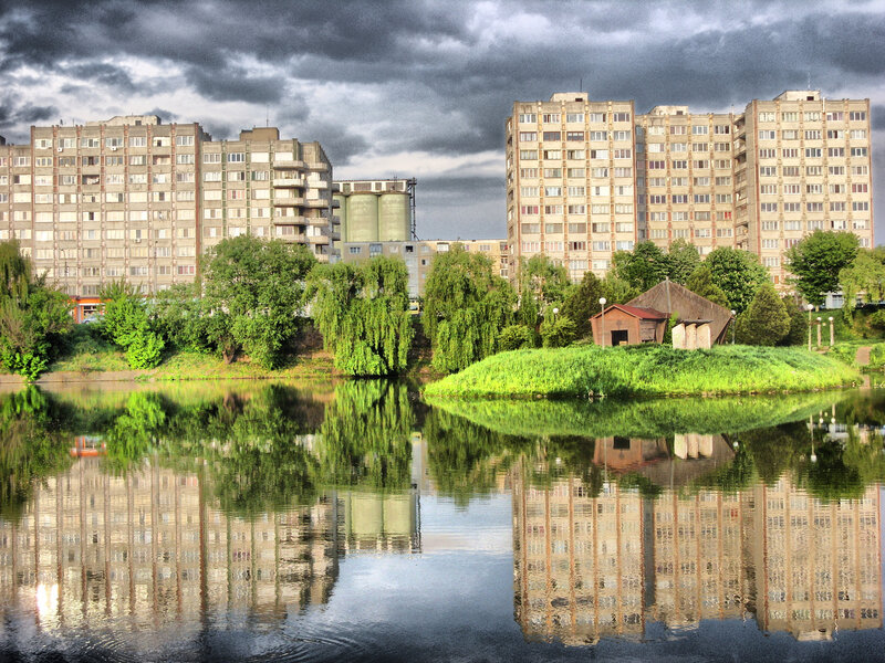 apartment buildings reflected in water