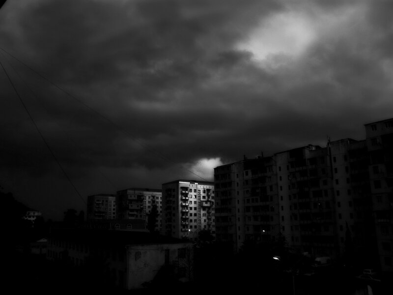 Apartment Buildings under Stormy Sky