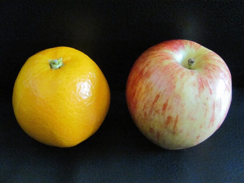 apple and orange on black