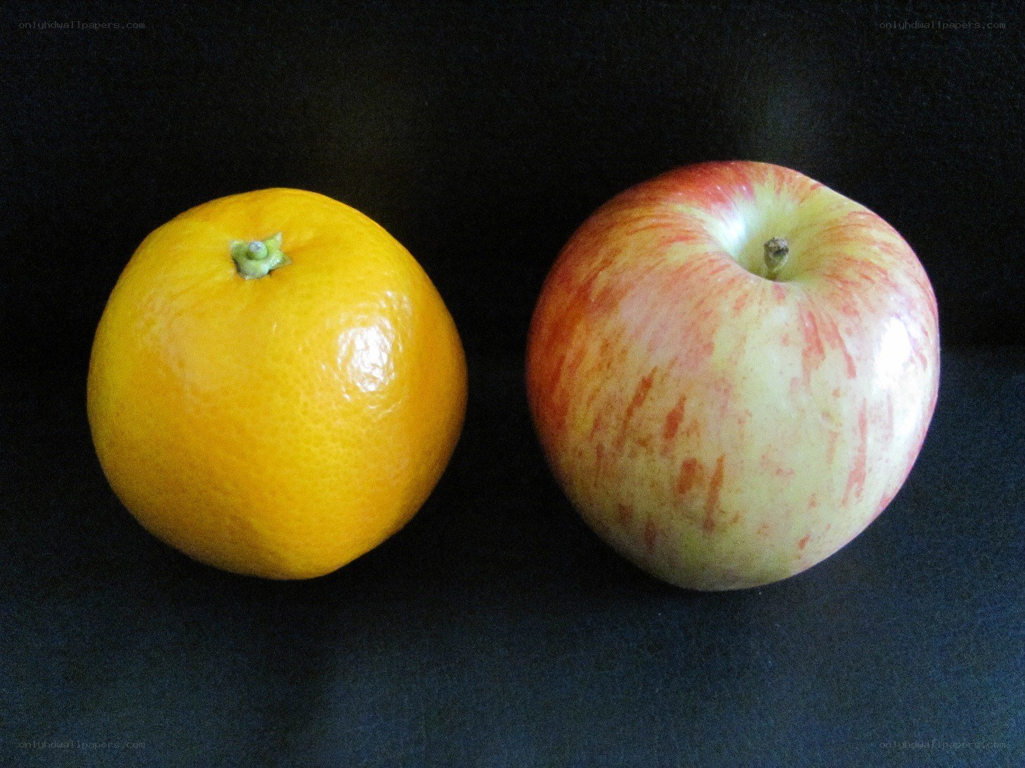 apple and orange on black