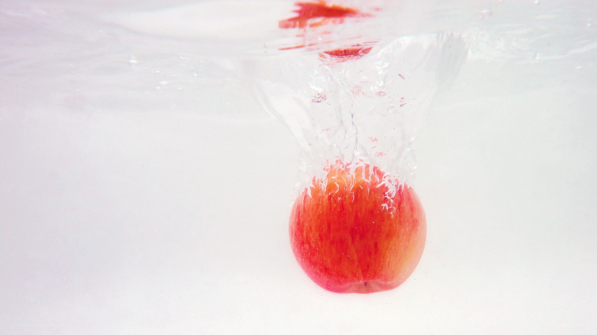 apple falling into water