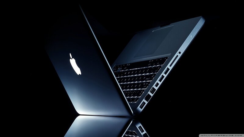 Apple laptop on dark background