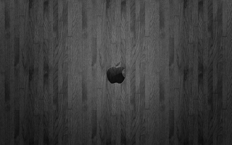 Apple logo on dark wood