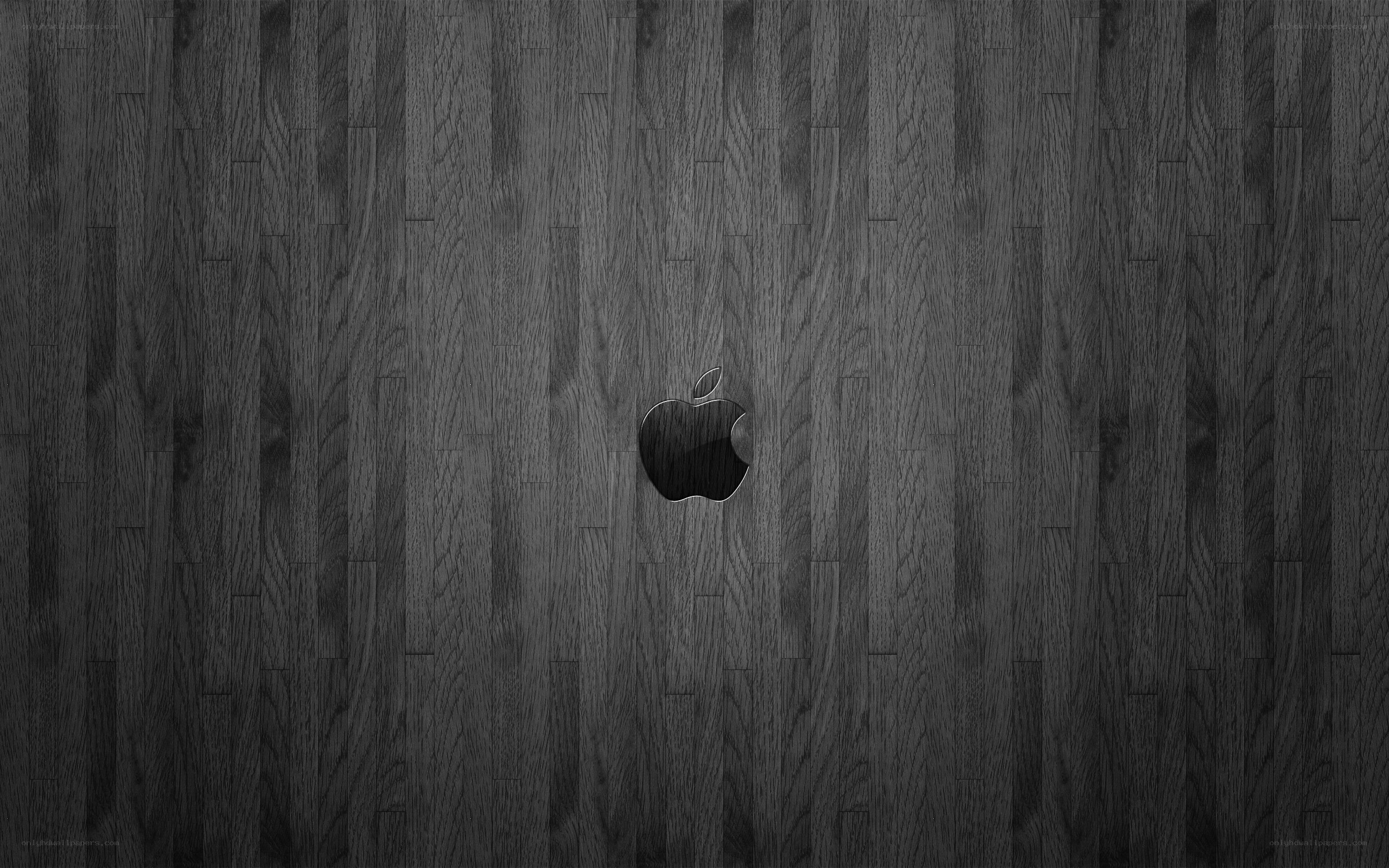 Apple logo on dark wood