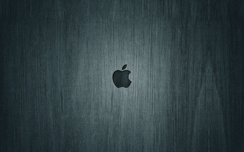 Apple logo on dark wood