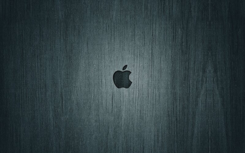Apple logo on dark wood