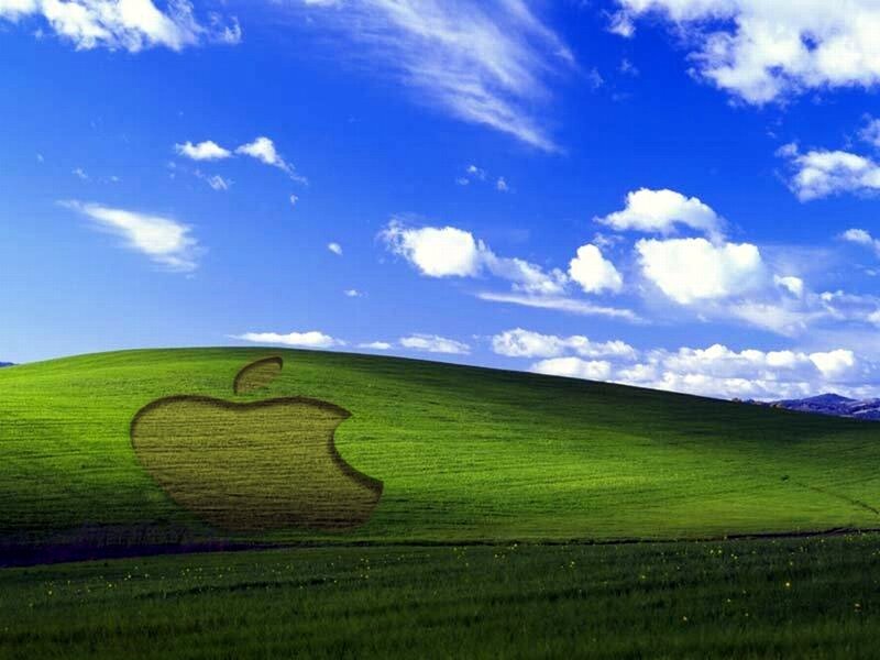 Apple logo on green hill