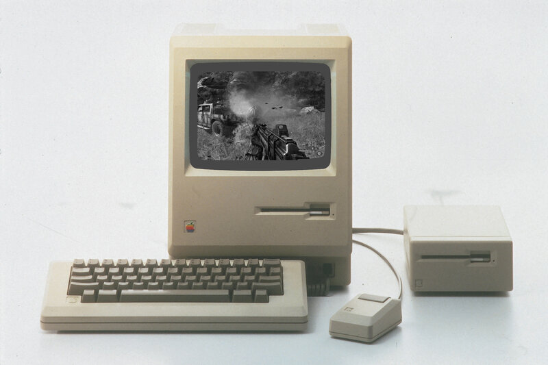 Apple Macintosh with game on screen