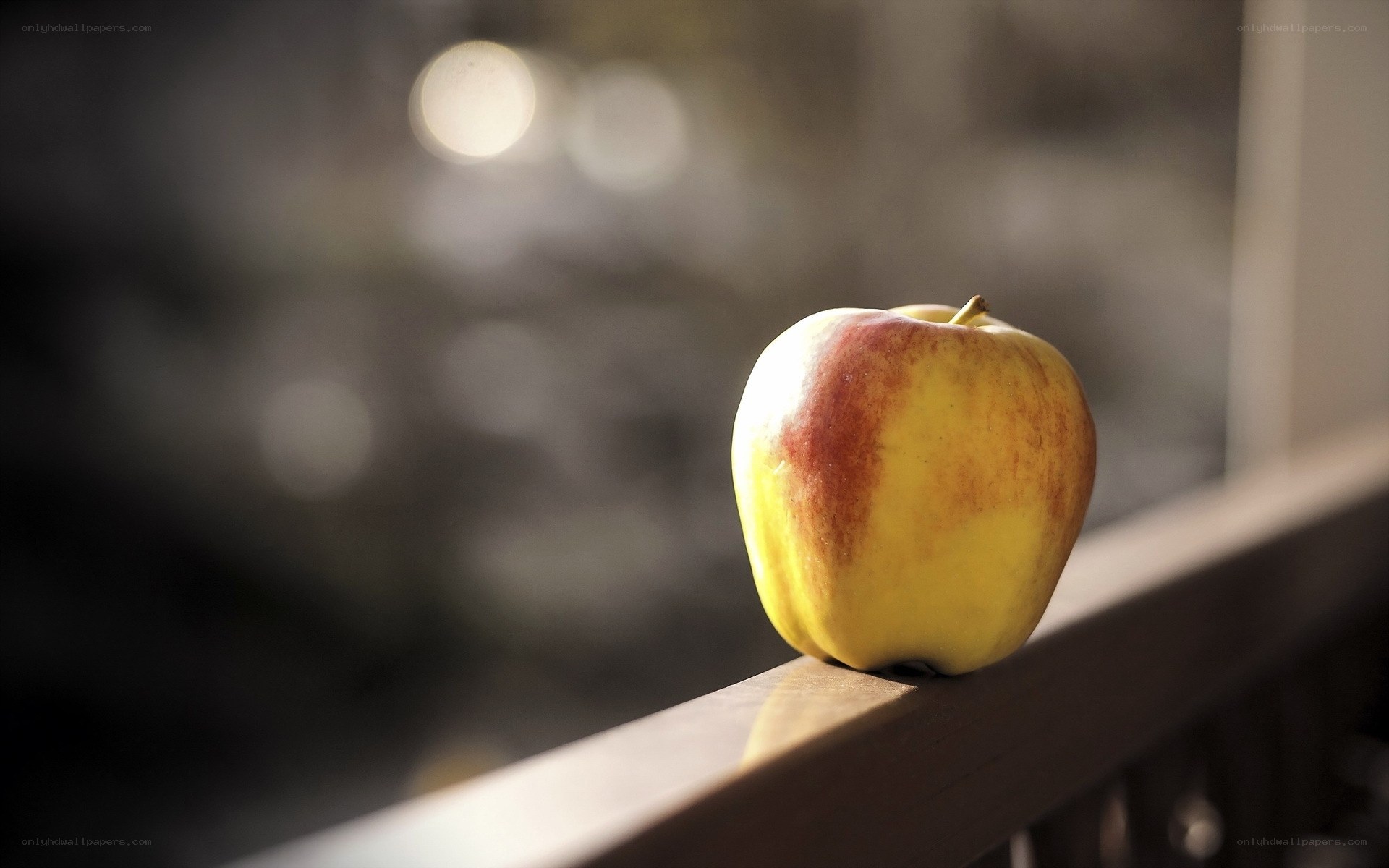 apple on a wooden railing