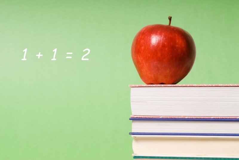 apple on books with math equation