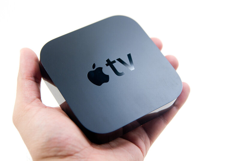 Apple TV device in hand